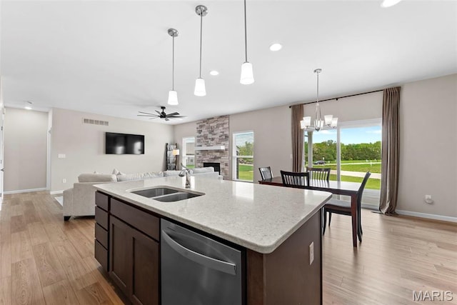 kitchen with stainless steel dishwasher, a sink, baseboards, dark brown cabinets, and a ceiling fan
