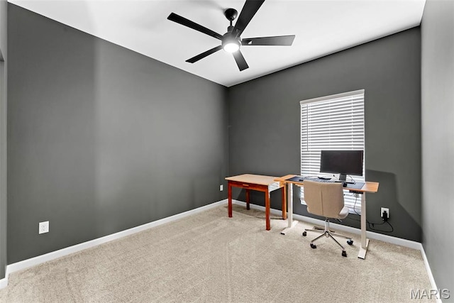 home office featuring carpet, baseboards, and a ceiling fan