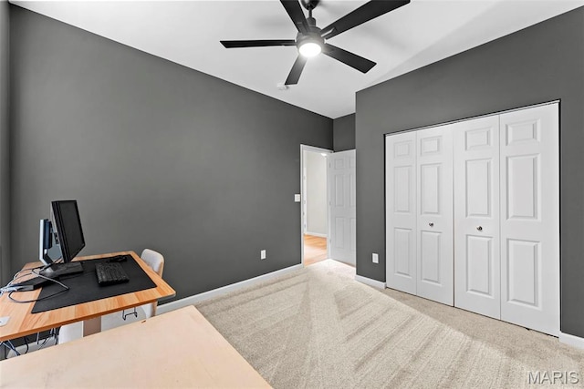 carpeted home office featuring ceiling fan and baseboards