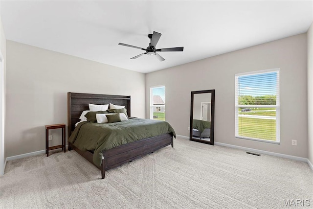 carpeted bedroom with baseboards and ceiling fan