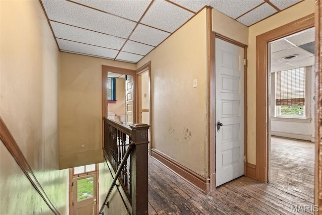 3456 Miami St, Saint Louis, MO 63118 - hallway with an upstairs landing, a drop ceiling, hardwood / wood-style flooring, and baseboards