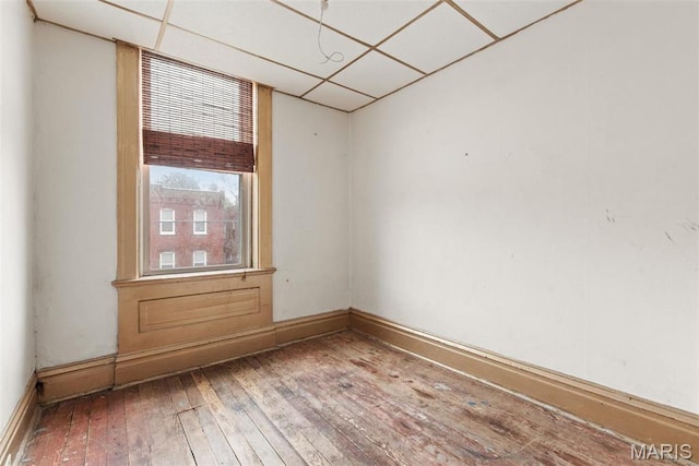 3456 Miami St, Saint Louis, MO 63118 - unfurnished room featuring hardwood / wood-style floors, a paneled ceiling, and baseboards