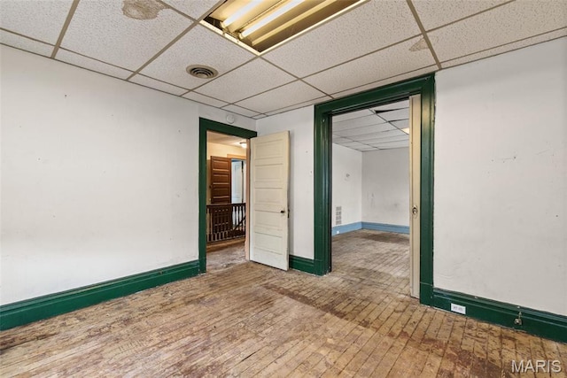 3456 Miami St, Saint Louis, MO 63118 - spare room featuring a paneled ceiling, hardwood / wood-style floors, and baseboards
