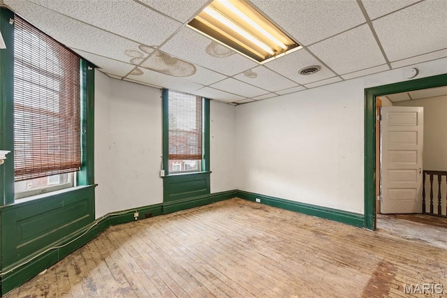 3456 Miami St, Saint Louis, MO 63118 - spare room with hardwood / wood-style floors, a paneled ceiling, and baseboards