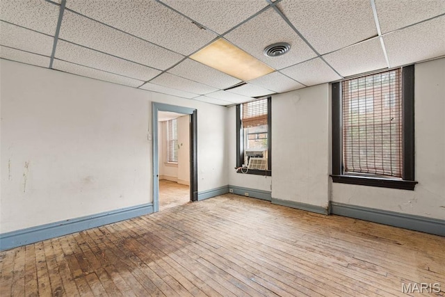 3456 Miami St, Saint Louis, MO 63118 - empty room with wood-type flooring, baseboards, a paneled ceiling, and cooling unit