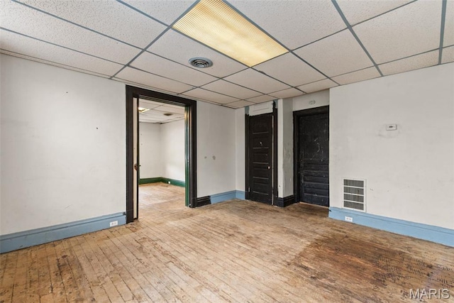 3456 Miami St, Saint Louis, MO 63118 - empty room featuring hardwood / wood-style floors, a paneled ceiling, and baseboards