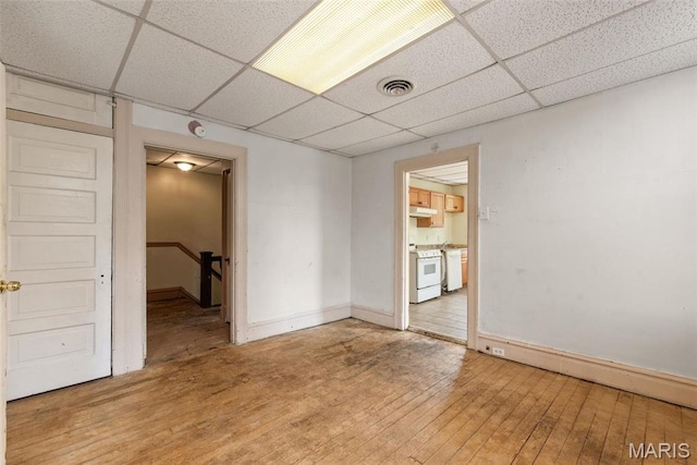 3456 Miami St, Saint Louis, MO 63118 - spare room featuring a paneled ceiling, light wood-style floors, and baseboards
