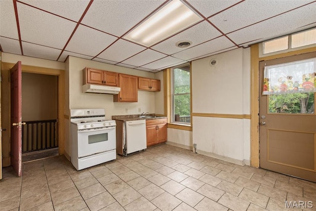 3456 Miami St, Saint Louis, MO 63118 - kitchen featuring white appliances, a drop ceiling, under cabinet range hood, light tile patterned floors, and a sink