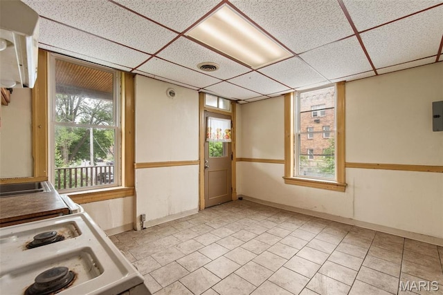 3456 Miami St, Saint Louis, MO 63118 - kitchen featuring a paneled ceiling, electric stove, light tile patterned floors, and baseboards
