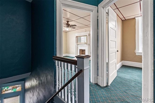3456 Miami St, Saint Louis, MO 63118 - hallway with an upstairs landing, dark carpet, and baseboards