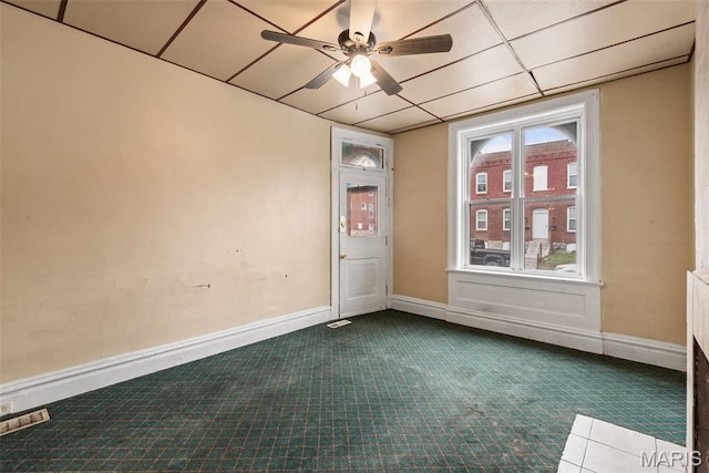 3456 Miami St, Saint Louis, MO 63118 - empty room with dark carpet, ceiling fan, and baseboards