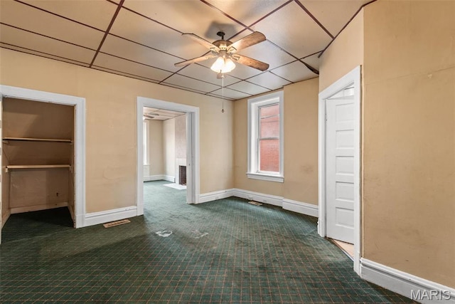 3456 Miami St, Saint Louis, MO 63118 - unfurnished bedroom featuring dark colored carpet, a drop ceiling, baseboards, and a spacious closet