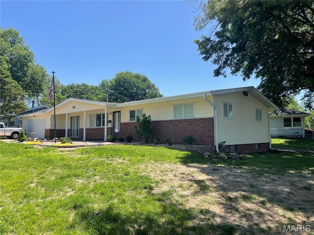 single story home with a garage, brick siding, and a front yard