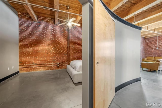 basement featuring brick wall, baseboards, and wooden ceiling
