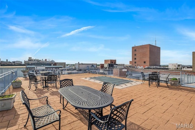 view of patio / terrace with outdoor dining space and a view of city