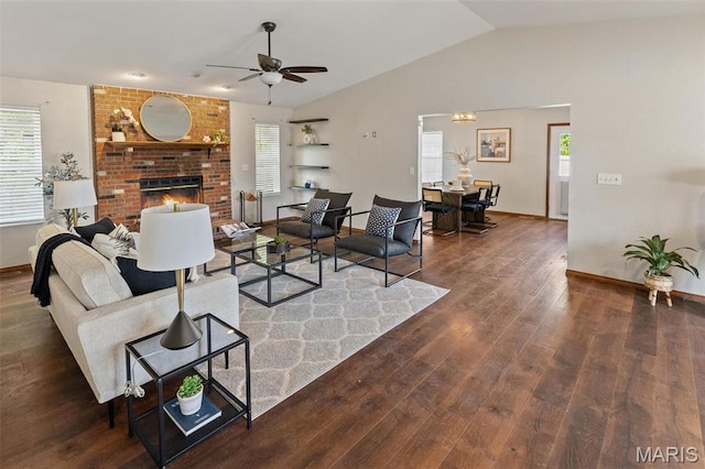 living room featuring ceiling fan, wood finished floors, plenty of natural light, lofted ceiling, and baseboards