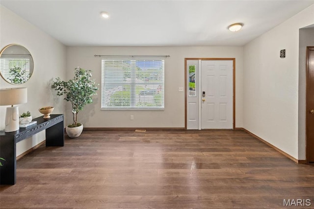 foyer entrance featuring wood finished floors and baseboards