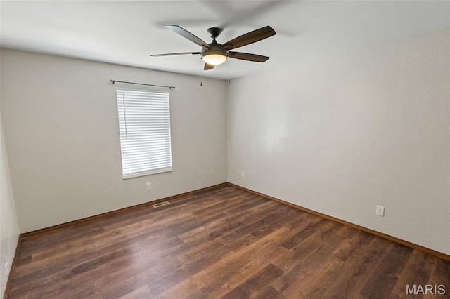 unfurnished room with a ceiling fan, wood finished floors, and baseboards
