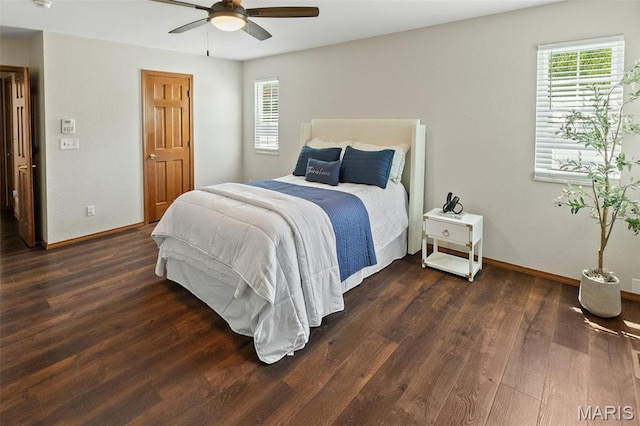 bedroom with dark wood-type flooring, baseboards, and ceiling fan