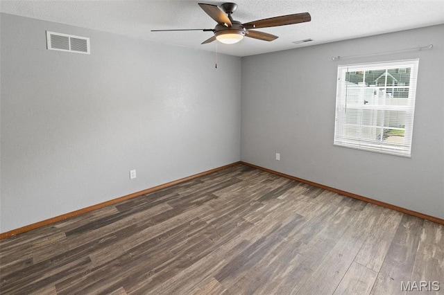 unfurnished room featuring wood finished floors, ceiling fan, baseboards, and a textured ceiling