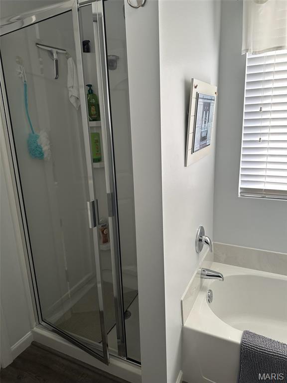 1805 Hyland Green Dr, Ofallon, MO 63366 - full bathroom featuring a shower stall, a bath, and wood finished floors