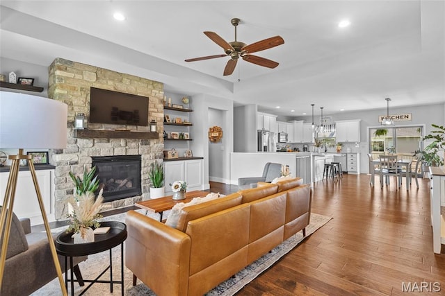 136 Oakshire Dr, Troy, IL 62294 - living room featuring a ceiling fan, dark wood-style floors, a stone fireplace, and recessed lighting