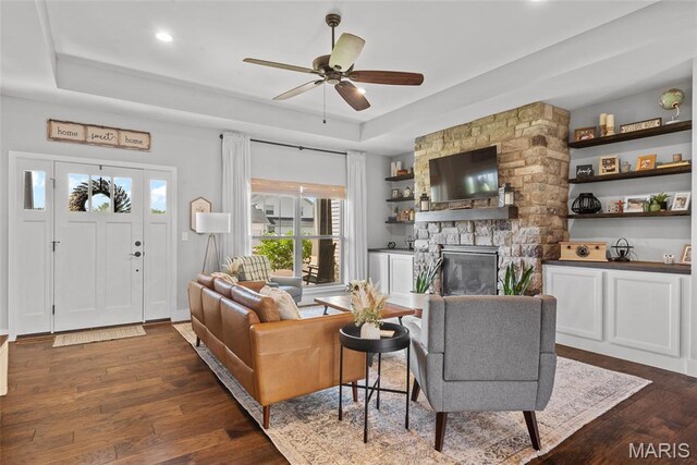 136 Oakshire Dr, Troy, IL 62294 - living area featuring a raised ceiling, a fireplace, ceiling fan, dark wood-style flooring, and recessed lighting