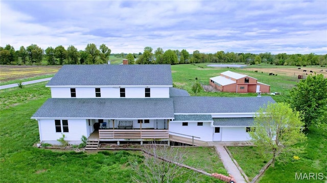 29595 State Highway 3, La Plata, MO 63549 - rear view of house featuring roof with shingles, a lawn, a chimney, a deck, and an outdoor structure