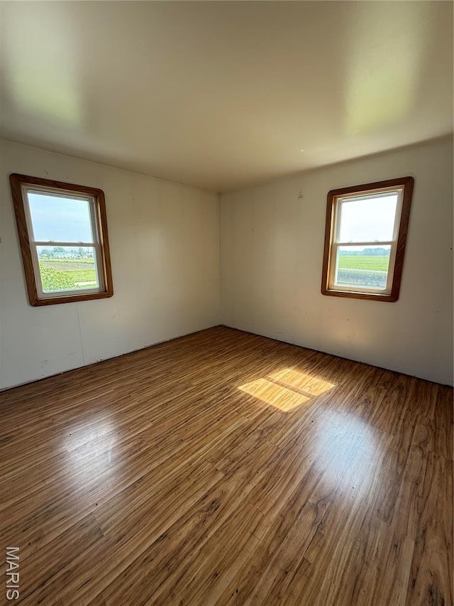 29595 State Highway 3, La Plata, MO 63549 - empty room with healthy amount of natural light and wood finished floors