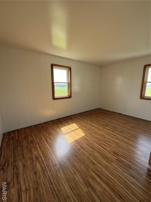 29595 State Highway 3, La Plata, MO 63549 - unfurnished room featuring wood finished floors and plenty of natural light