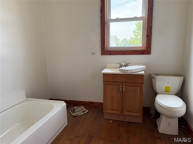 29595 State Highway 3, La Plata, MO 63549 - full bath with a bath, vanity, wood finished floors, and toilet