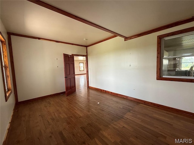 29595 State Highway 3, La Plata, MO 63549 - empty room featuring dark wood-style flooring, baseboards, and ornamental molding