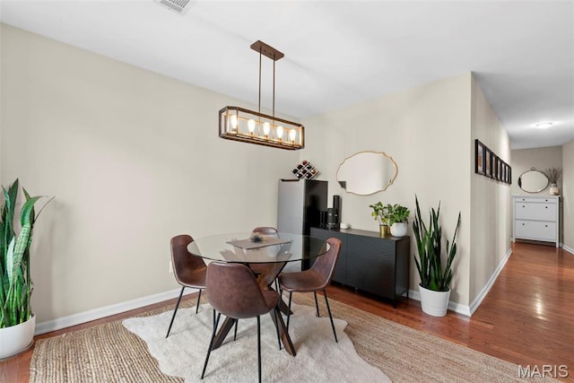 4260 Lindell Blvd Unit B, Saint Louis, MO 63108 - dining space with wood finished floors, baseboards, and a chandelier