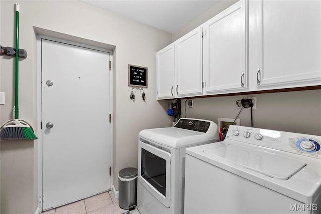4260 Lindell Blvd Unit B, Saint Louis, MO 63108 - washroom with cabinet space, washing machine and dryer, and light tile patterned flooring