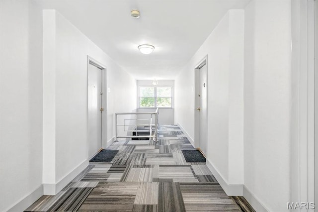 5 Delcrest Ct Unit 203, Saint Louis, MO 63124 - hallway with an upstairs landing, carpet, and baseboards