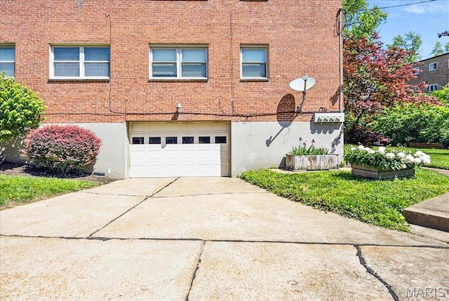 5 Delcrest Ct Unit 203, Saint Louis, MO 63124 - view of front of house featuring a garage, driveway, and brick siding