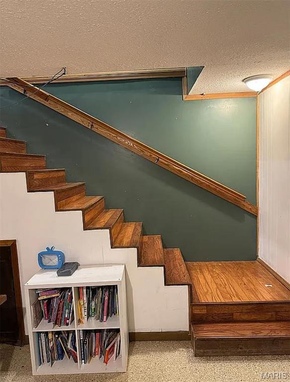 23784 Maries Road 410th Rd, Belle, MO 65013 - stairway featuring a textured ceiling and baseboards
