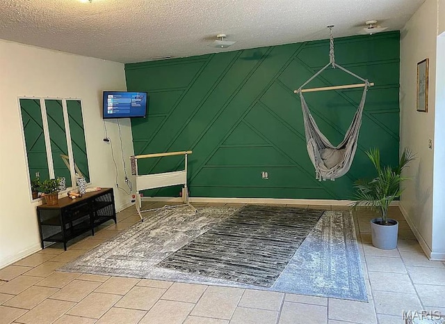 23784 Maries Road 410th Rd, Belle, MO 65013 - tiled bedroom with a textured ceiling, baseboards, and a decorative wall