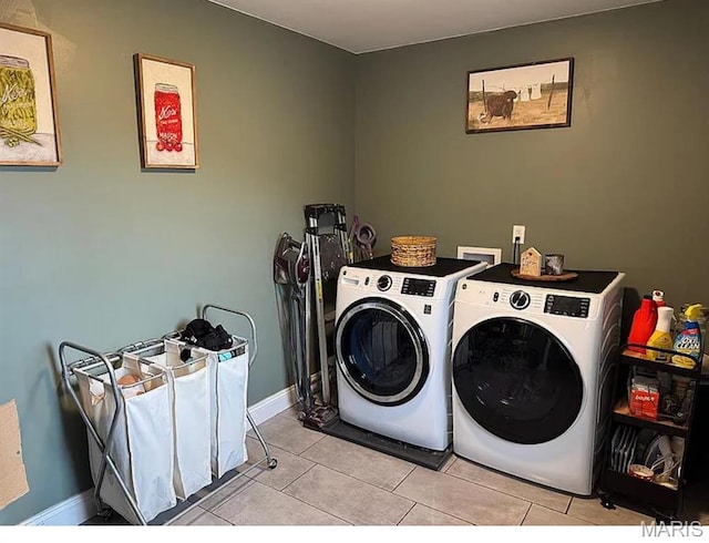 23784 Maries Road 410th Rd, Belle, MO 65013 - washroom with washing machine and dryer, light tile patterned floors, and baseboards