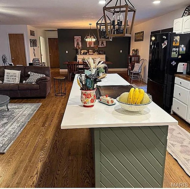 23784 Maries Road 410th Rd, Belle, MO 65013 - kitchen featuring freestanding refrigerator, white cabinets, wood finished floors, a chandelier, and decorative light fixtures