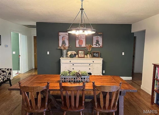 23784 Maries Road 410th Rd, Belle, MO 65013 - dining area featuring dark wood finished floors, baseboards, and a textured ceiling