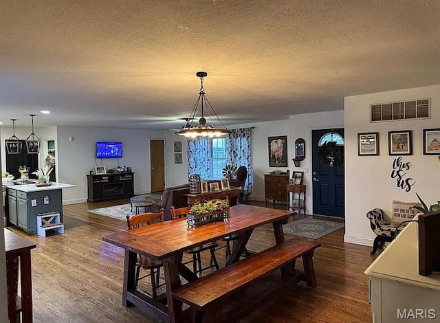 23784 Maries Road 410th Rd, Belle, MO 65013 - dining area featuring a textured ceiling, dark wood-style flooring, and baseboards