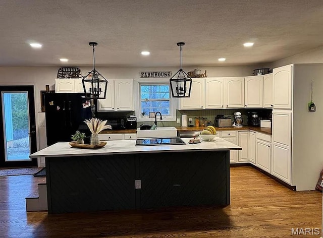 23784 Maries Road 410th Rd, Belle, MO 65013 - kitchen with black appliances, a kitchen island, a sink, white cabinetry, and pendant lighting