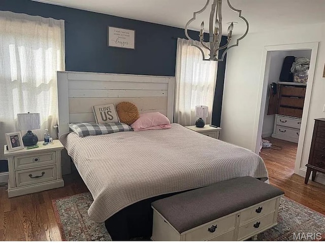 23784 Maries Road 410th Rd, Belle, MO 65013 - bedroom featuring a chandelier and dark wood-style floors