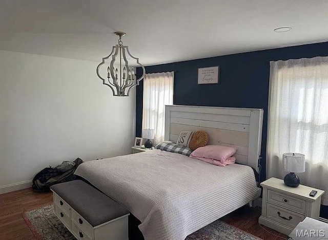 23784 Maries Road 410th Rd, Belle, MO 65013 - bedroom featuring a chandelier, dark wood-style flooring, and baseboards