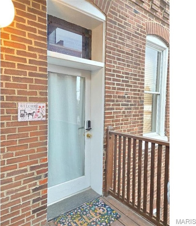 property entrance with brick siding