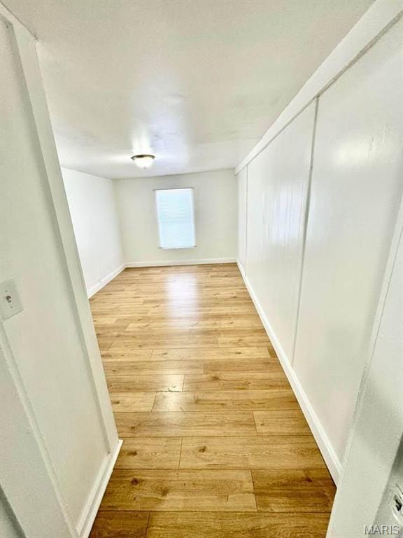 10117 Duke Dr, Saint Louis, MO 63136 - empty room with light wood-style floors and baseboards