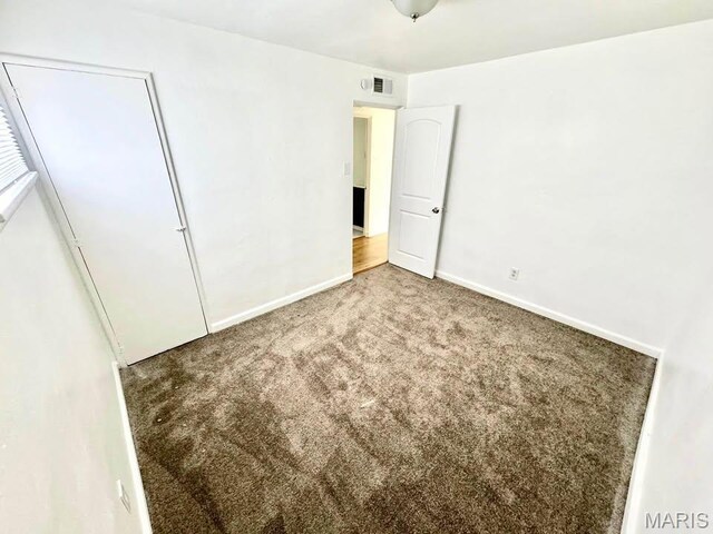 10117 Duke Dr, Saint Louis, MO 63136 - unfurnished bedroom with carpet floors and baseboards