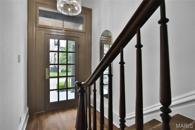 6504 Michigan Ave, Saint Louis, MO 63111 - doorway to outside with a chandelier, dark wood finished floors, stairway, and baseboards