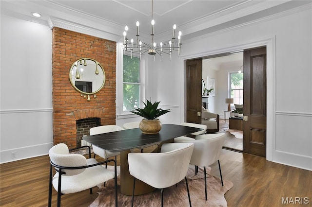 6504 Michigan Ave, Saint Louis, MO 63111 - dining area featuring a chandelier, wood finished floors, crown molding, and a brick fireplace